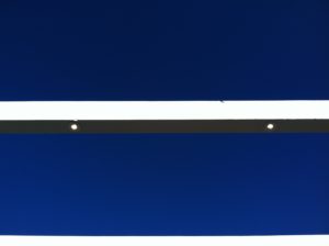 Exterior soffit lighting detail against deep blue trim