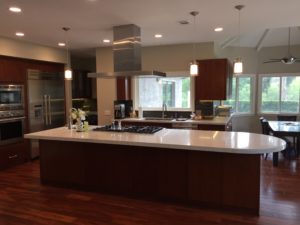 Modern kitchen with island cooktop and pendant lighting