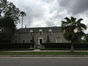 Two-story traditional stucco home with symmetrical facade
